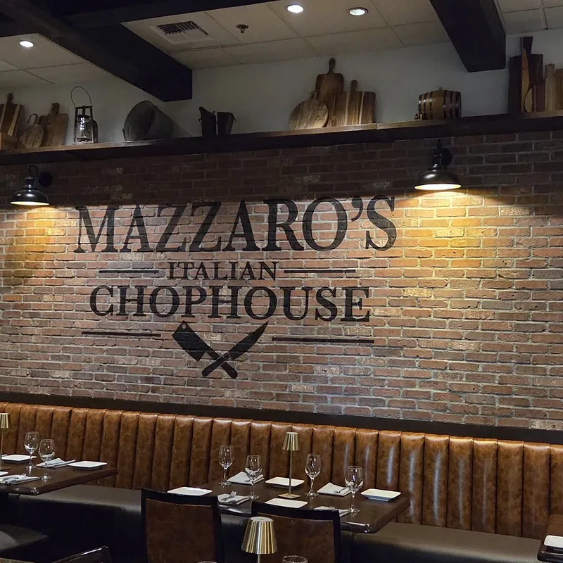 Banquette seating along the brick brand wall, tables set for dinner