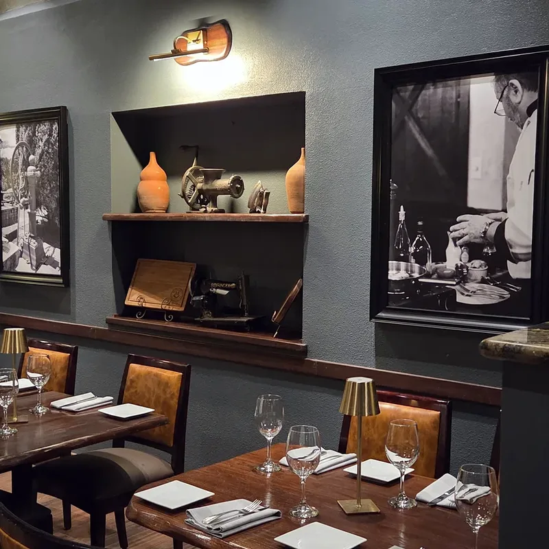 Set tables under wall sconces and framed prints