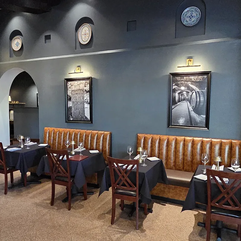 The blue-grey dining room with arched doorways and leather banquettes