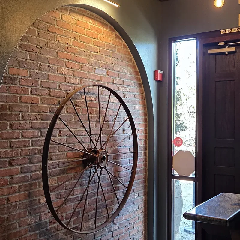 The brick entry arch with the iron wagon wheel