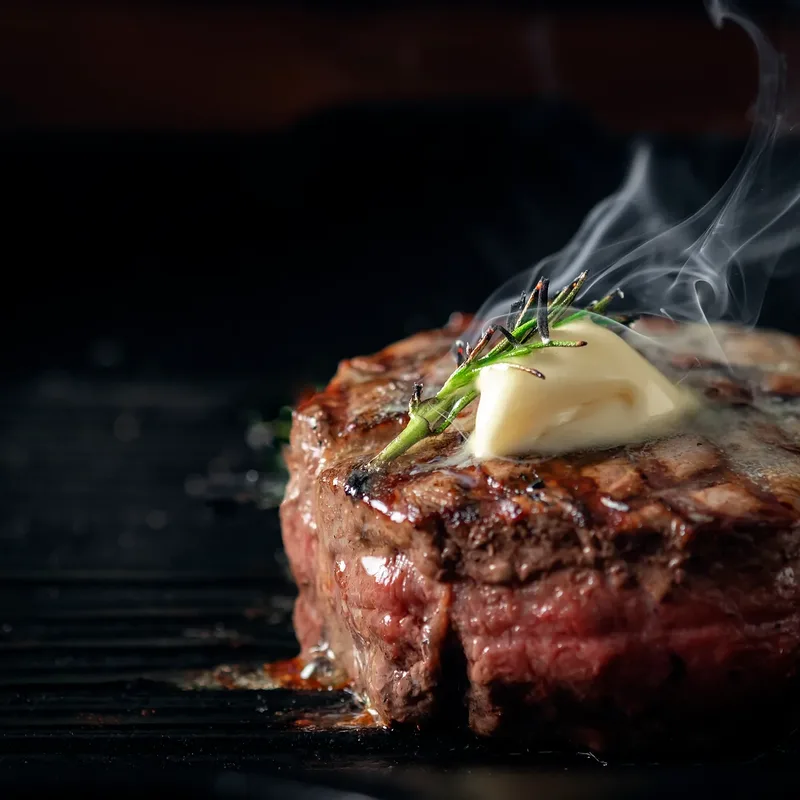 Filet mignon with herb butter, still smoking off the grill